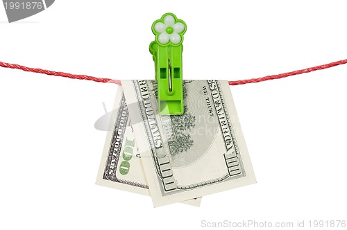 Image of One hundred dollar on clothesline