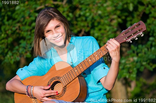 Image of Teenage girl with guitar