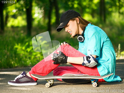 Image of Teenage girl with skateboard