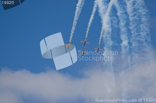 Image of four planes in formation with vapour trails