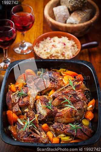 Image of Roasted pork belly on vegetables with sauerkraut