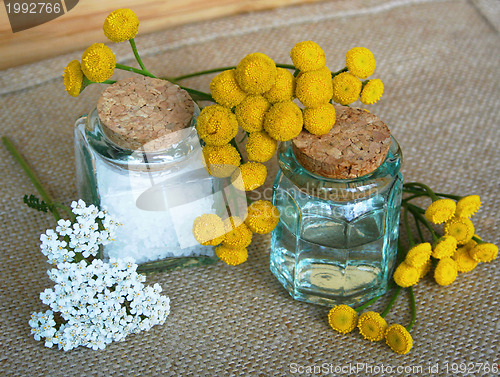 Image of Bottles of essential oil and sea salt in spa composition 