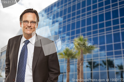 Image of Handsome Businessman Smiling in Front of Building