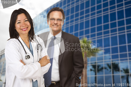 Image of Hispanic Doctor or Nurse and Businessman in Front of Building