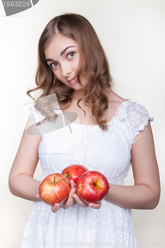 Image of Girl with three apples in their hands