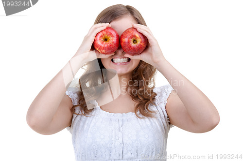 Image of Woman holding two red apples for eyes