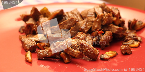 Image of meat on red dish