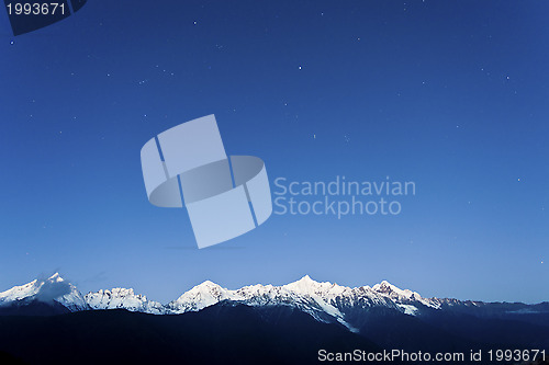 Image of Snow mountain at dawn with stars