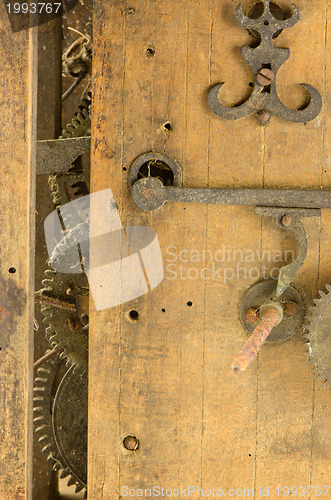 Image of Retro wooden clock grunge mechanism gear closeup 