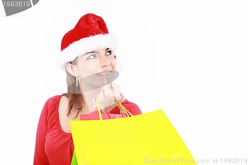 Image of Attractive woman in Christmas cap hands packets, isolated on whi