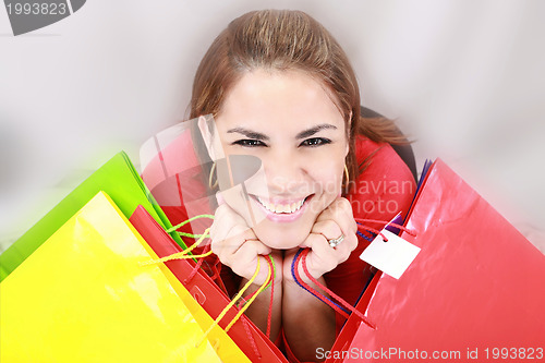 Image of Beautiful shopping woman holding bags 