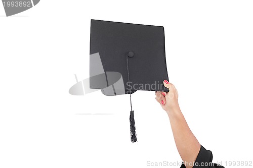 Image of hand throwing graduation hats in the air 