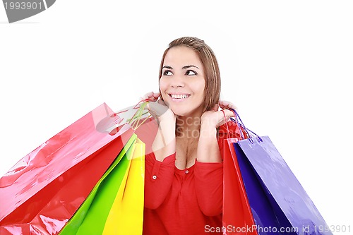 Image of Shopping woman holding shopping bags looking up to the side on w