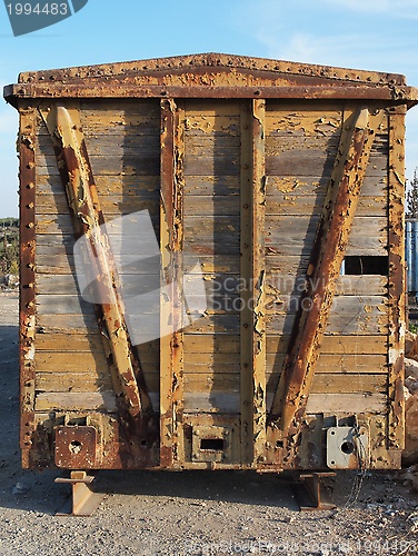 Image of Back end of abandoned wooden railway car standing on props