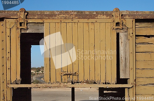 Image of Detail of a broken door of abandoned wooden railway car 