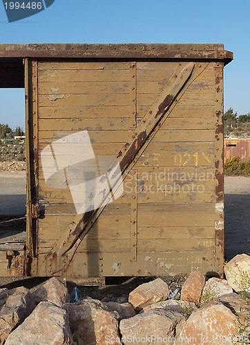 Image of Detail of abandoned wooden railway car standing on props