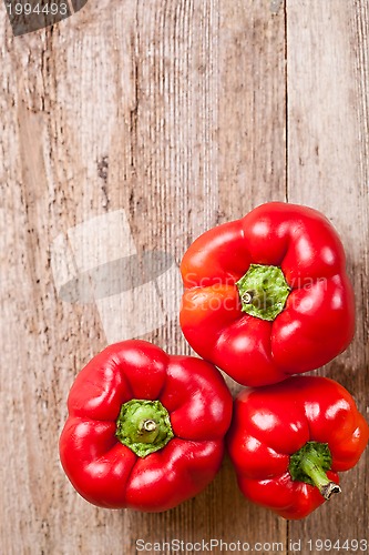 Image of three red bell peppers