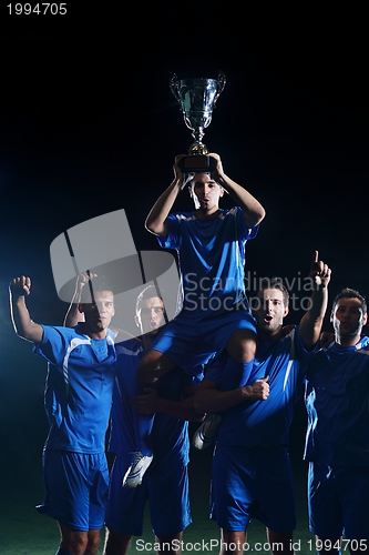 Image of soccer players celebrating victory