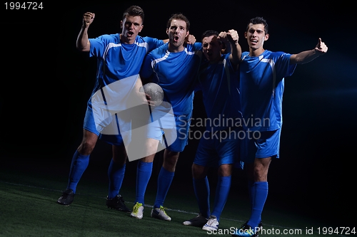 Image of soccer players celebrating victory