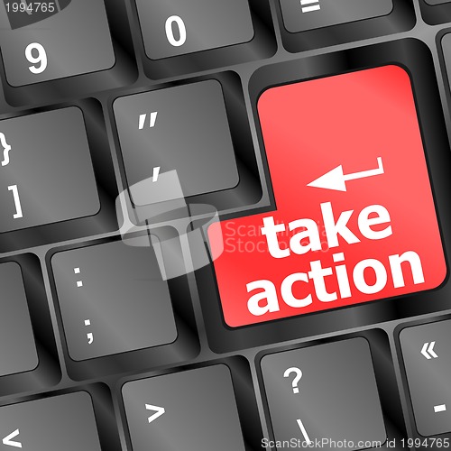 Image of Take action red key on a computer keyboard, business concept