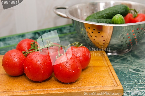 Image of red tomato and green cucumbers