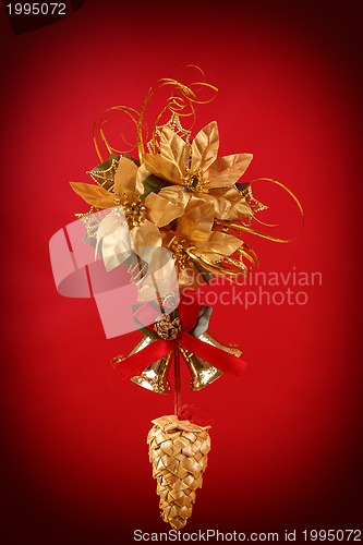 Image of christmas decoration with cone , bells and golden flower