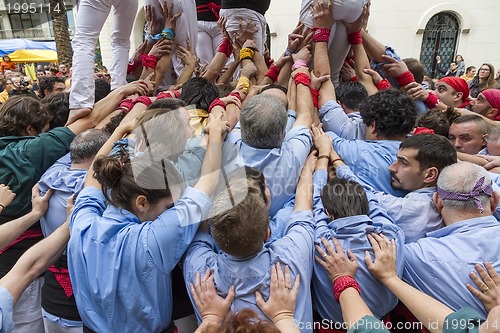 Image of Castellers, arms supporting the tower