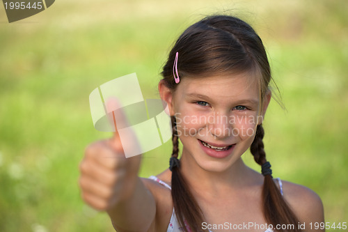 Image of Young girl giving thumbs up