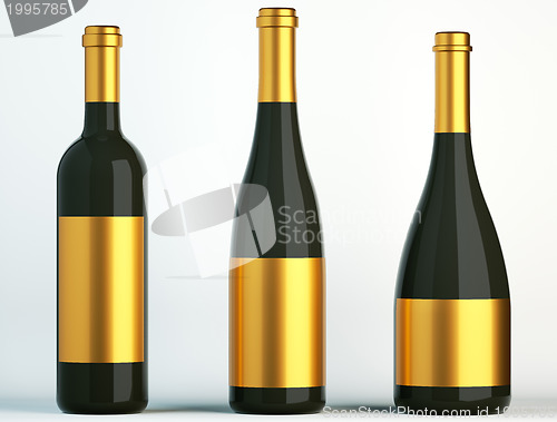 Image of Three black bottles for wine with golden labels 