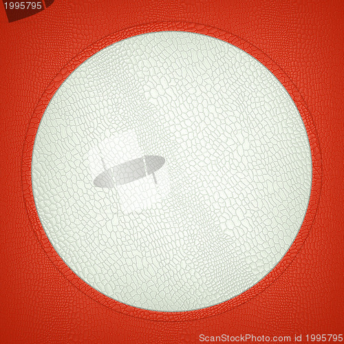Image of Red and white stitched circle shape on mock croc