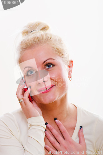Image of The young woman talks by a mobile phone