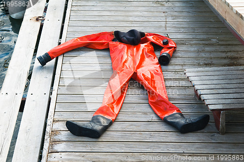 Image of The diving suit lays on a pier