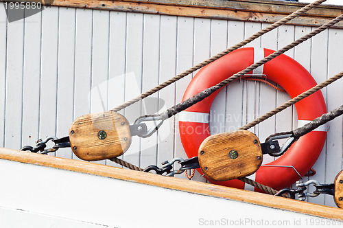 Image of Ancient wooden sailboat pulleys and ropes detail 