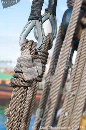 Image of Ancient wooden sailboat pulleys and ropes detail 