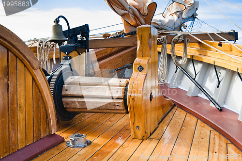 Image of ship's Bell and anchor lifting mechanism on an old sailboat 