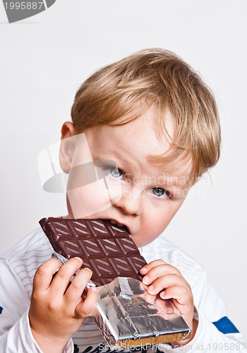 Image of The little boy eats chocolate