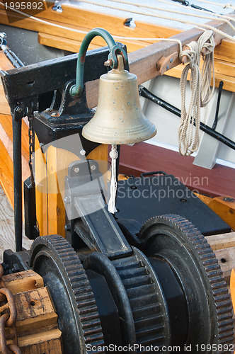 Image of ship's Bell and anchor lifting mechanism on an old sailboat 