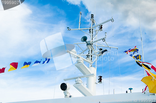 Image of Mast with the navigating equipment of a yacht and alarm flags