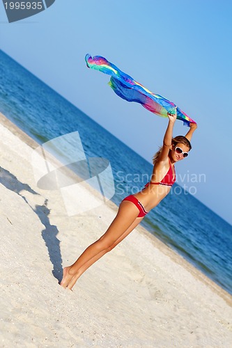 Image of Nice teen girl standing on the beach