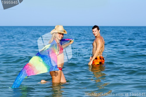 Image of Smiling teen girl and young man