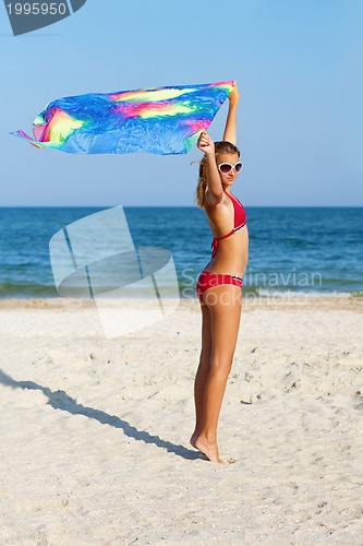 Image of Beautiful teen girl standing on the beach