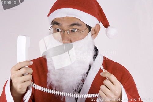 Image of Asian Santa Claus With Telephone