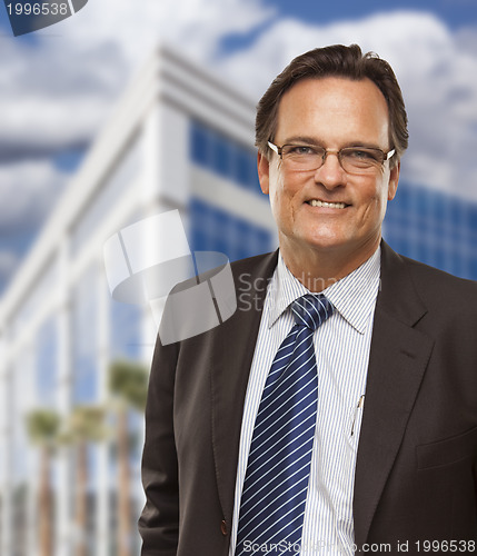 Image of Handsome Businessman Smiling in Front of Building