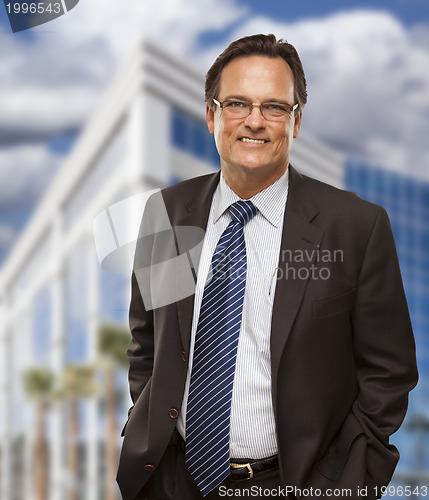 Image of Handsome Businessman Smiling in Front of Building