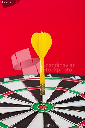 Image of Dart sticks to bullseye on a dart board