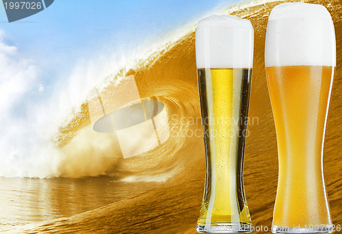 Image of Two glasses of gold beer over the big beer wave