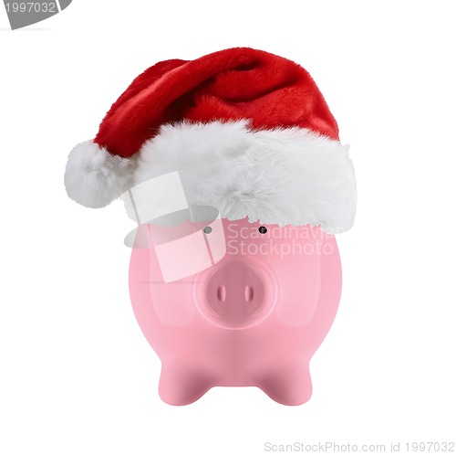 Image of Piggy bank with christmas hat isolated