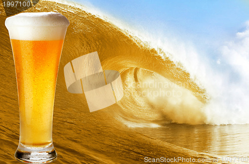 Image of Gold beer glass over a big beer wave.