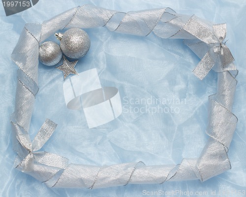 Image of christmas ball on blue silk frame