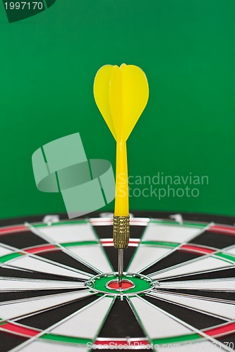 Image of Dart sticks to bullseye on a dart board